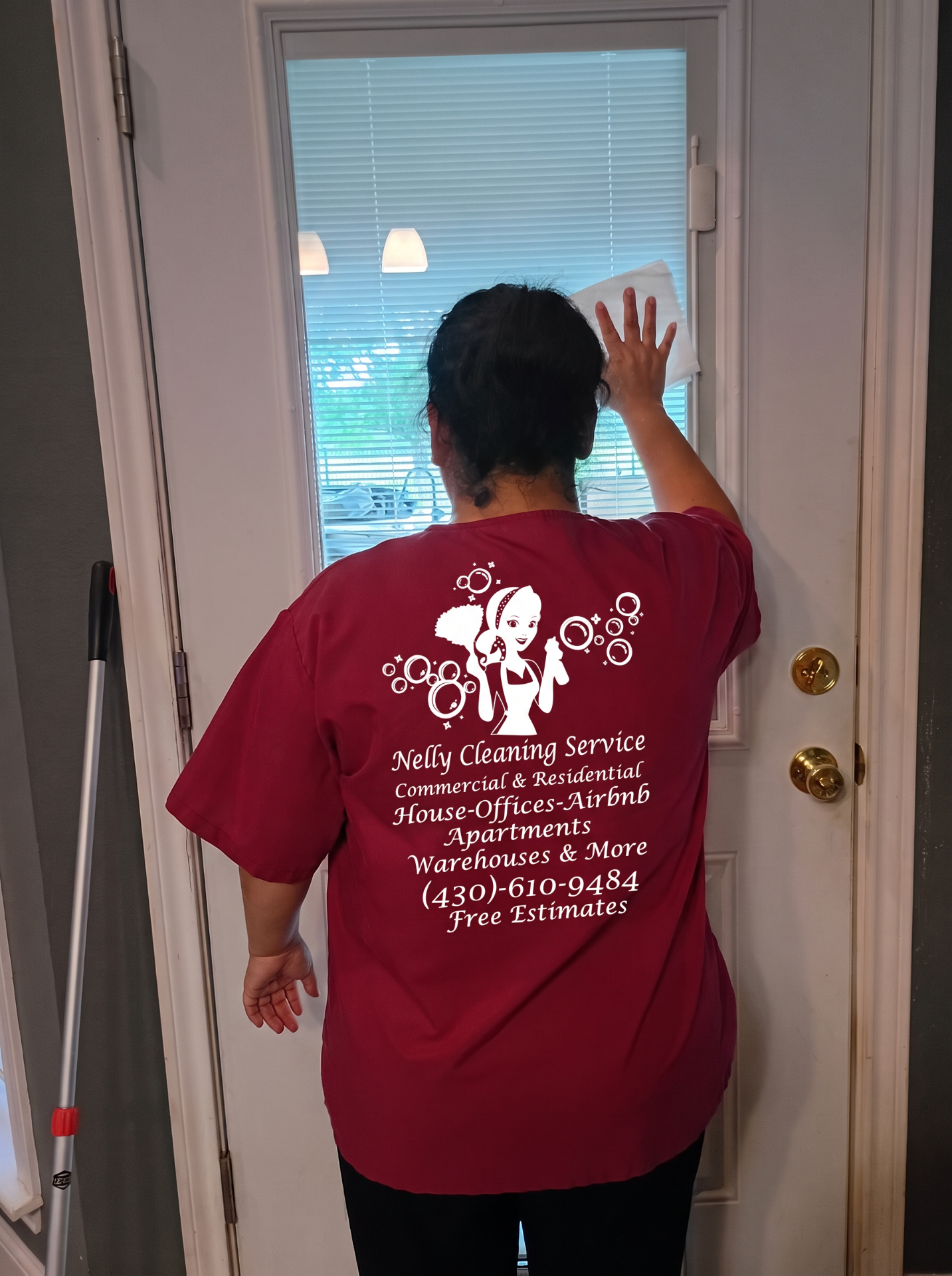 Nelly Cleaning Service team member cleaning a window
